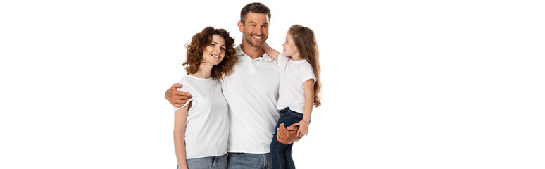 Fototapeta premium horizontal image of happy father holding in arms cute daughter and hugging curly wife isolated on white
