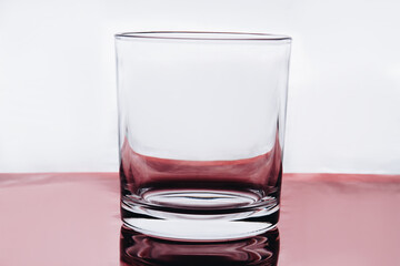 Empty small shot glass on white background. Whiskey clear glass.