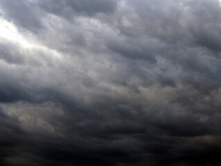 Dark gray heavy clouds in the sky before a thunderstorm. Natural gloomy sinister background....