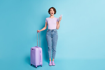 Full body photo of astonished girl tourist hold luggage use cellphone impressed quarantine border...