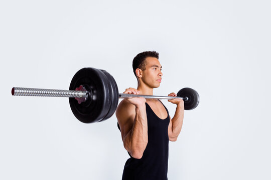 Profile side view portrait of his he nice attractive content sportive strong purposeful focused guy doing exercise lifting barbell body sculpt isolated over light gray pastel color background