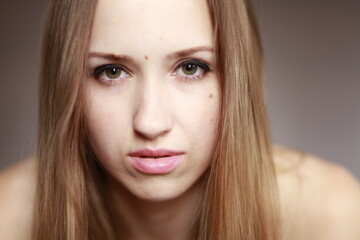 Fototapeta premium Emotional girl portrait on the brown background