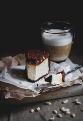 Cheesecake with cappuccino on a book