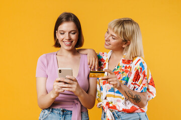 Portrait of two cheerful lovely girlfriends standing