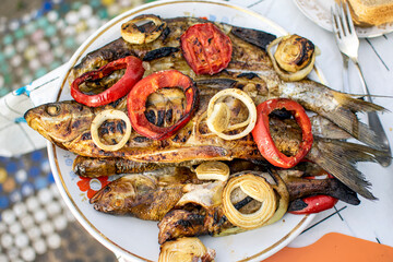 Fried fish on a plate close-up.