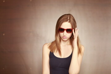 Girl in glasses. Girl portrait in red glasses. Beautiful young curious woman. Woman watching.