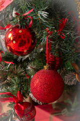red Christmas balls on a decorated Christmas tree