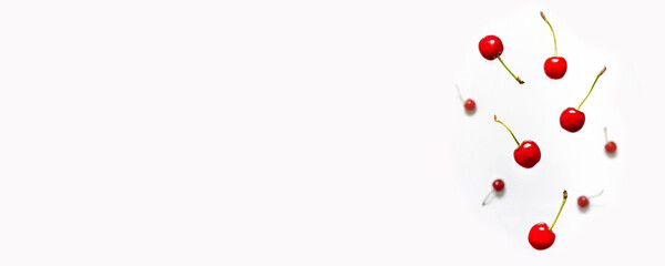 Organic fresh cherry levitation pattern on a white background. Fall cherry with green leaves, healthy diet concept