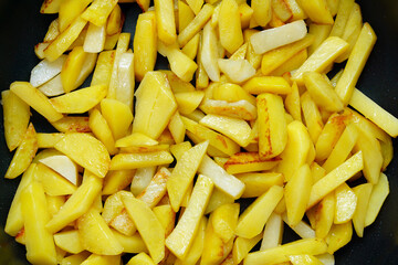 Cooking vegetables. Raw potatoes, cut into strips, cooking