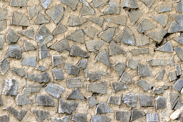 Rustic antique wood background of an old farm house wall made with clay and wooden logs.