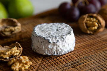 Premium organic goat cheese  on a rustic wooden cheese maker.