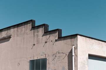 A particular roof of an old building with rectangular windows (Pesaro, Italy, Europe)