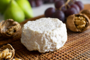 Fototapeta na wymiar Premium organic goat cheese on a rustic wooden cheese maker.