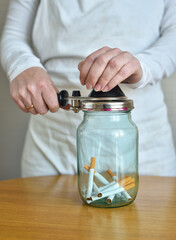 Fototapeta na wymiar cigarettes in a glass jar. smoking concept