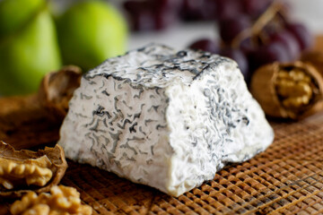 Premium organic goat cheese  on a rustic wooden cheese maker.