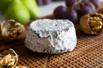 Premium organic goat cheese  on a rustic wooden cheese maker.