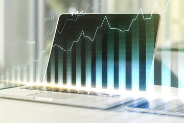 Abstract creative financial graph on modern laptop background, forex and investment concept....