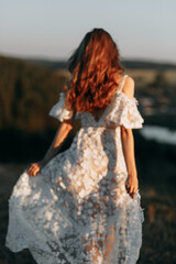 Fototapeta na wymiar Beautiful bride in nature in boho style. Wedding in the European style of fineart at sunset.