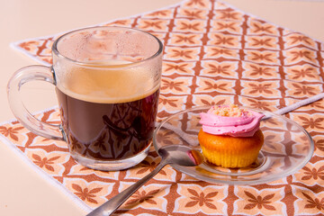 White plate with muffins, cakes, coffee mug on a yellow napkin