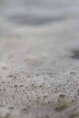 Fototapeta na wymiar Small bubbles in coastal water. 