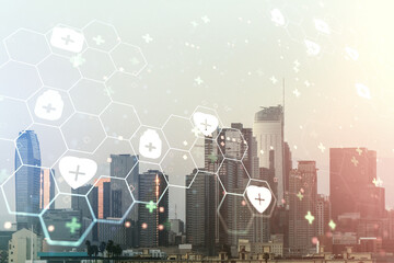 Double exposure of abstract virtual medical hologram on Los Angeles city skyscrapers background. Healthcare technolody concept
