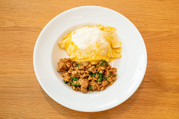 stir-fried pork and basil with creamy omelet on rice