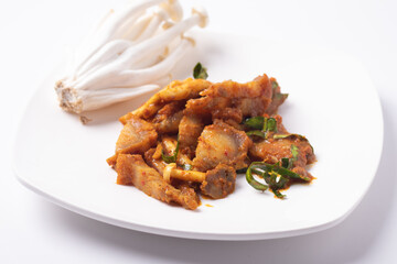 Stir fried crispy pork chilies in a white plate.