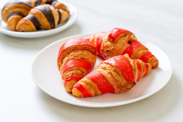 fresh croissant with strawberry jam sauce