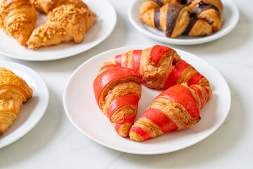 fresh croissant with strawberry jam sauce