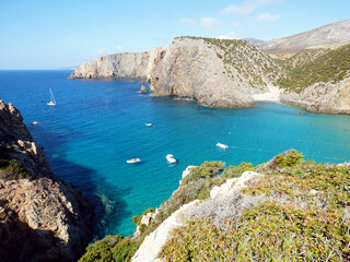 Cala Domestica, view of the bay from above along a path, some boats are moored