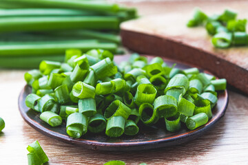 Sliced green onion rings in a bowl on the table.