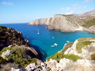 Cala Domestica, view of the bay from above along a path, some boats are moored