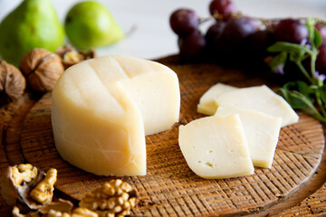 Premium organic goat cheese  on a rustic wooden cheese maker.