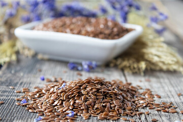Flax seeds or flaxseed are on old boards.