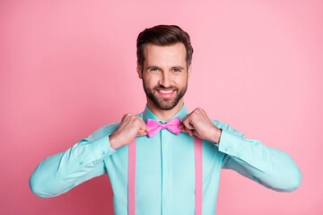 Photo of handsome macho guy trend clothes preparing corporate party retro theme well-dressed wear teal shirt suspenders bow tie isolated pastel pink color background - Powered by Adobe