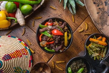 High angle shot of delicious traditional Ethiopian food with vegetables on a wooden surface