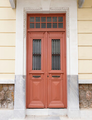 Fototapeta na wymiar Family House Traditional Entrance Wooden Door by the sidewalk, Athens Greece