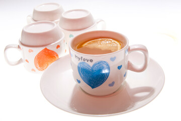 A mug of lemon tea and a few inverted cups