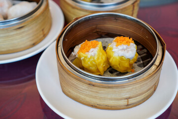 Shrimp Dumpling. A  famous Chinese Dim Sum. A streamed dim sum with shrimp and pork inside on bamboo basket.