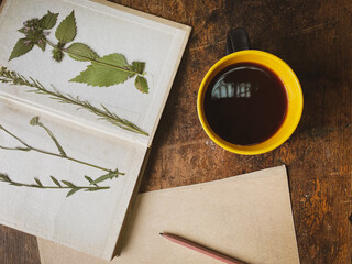 cup of coffee, dried flowers and a book
