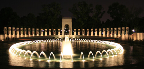 Illuminated view of the World War II Memorial and the central fountain in Washington, DC