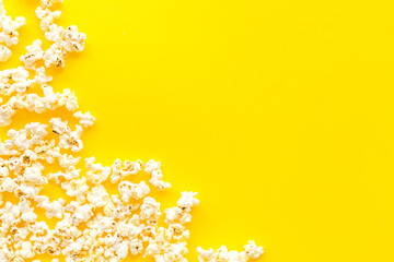 Fototapeta na wymiar Popcorn frame on yellow background top view copy space
