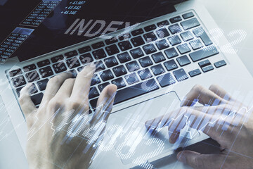 Double exposure of abstract creative financial chart with hand typing on computer keyboard on background, research and strategy concept