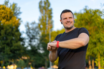 Technology for sport and active living. Athlete man talking into smartwatch wearable tech device...