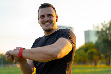 Technology for sport and active living. Athlete man talking into smartwatch wearable tech device speaking to someone or dictating message on smart watch app.