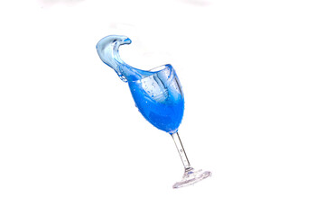 Blue splash water out of a glass on  white background.