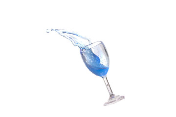 Blue splash water out of a glass on a white background.