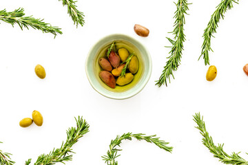 Fototapeta na wymiar Mixed olives in bowl and rosemary branches top view