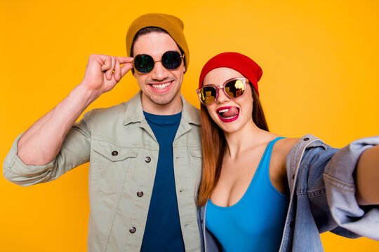 Closeup photo of funky crazy lady guy young couple together cool youth making selfies having fun vacation wear casual summer clothes isolated bright yellow color background