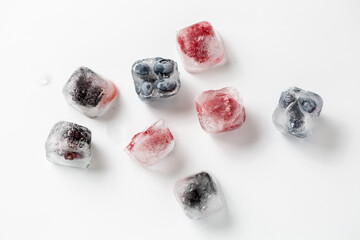 Obraz na płótnie Canvas ice cube with raspberry and blueberry